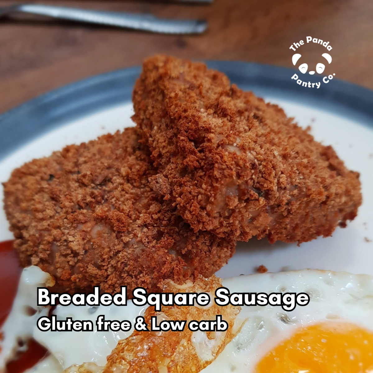 Two golden-brown breaded square sausage patties on a white plate with a blue rim, served with a fried egg. Text overlay reads 'Breaded Square Sausage Gluten free & Low carb' and a logo for 'The Panda Pantry Co.